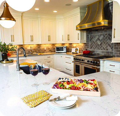 “Contemporary kitchen with subway tile backsplash, stainless steel range, and gold accents.”