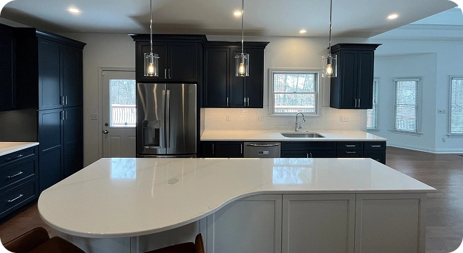 Contemporary kitchen featuring a sleek white countertop paired with black wooden cabinetry and accents, creating a bold contrast in design.