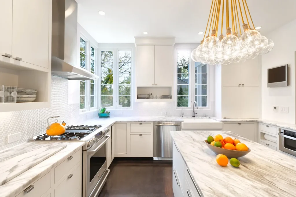 “Open-concept kitchen with marble island, stainless steel appliances, and adjoining living room.”